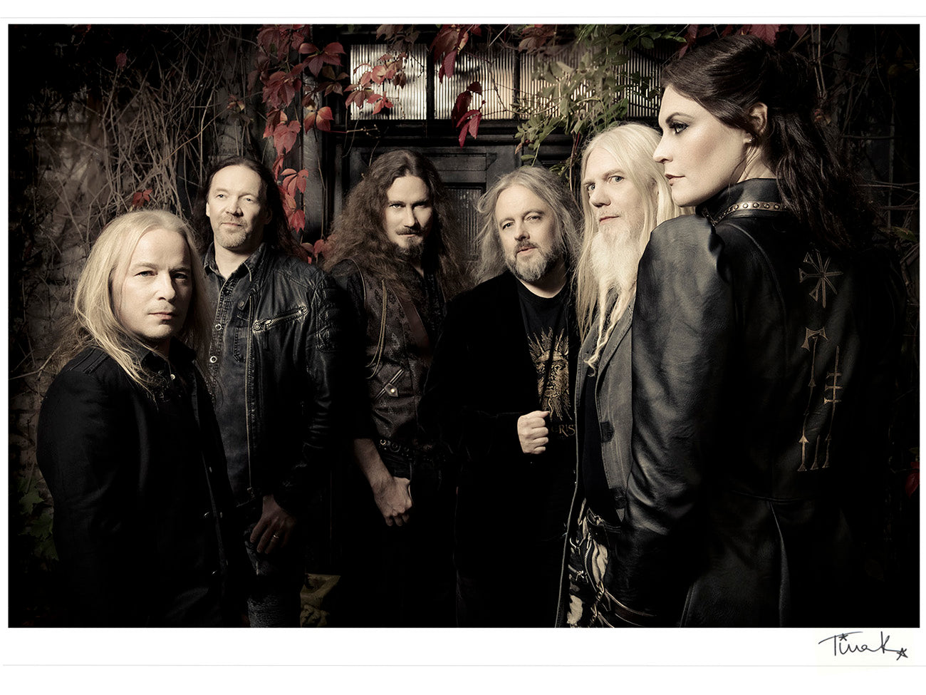 Framed photo print of symphonic metal band Nightwish from the Human Nature album promo shoot. The band are dressed in black, surrounded by autumnal leaves. Signed print by Tina K Photography.