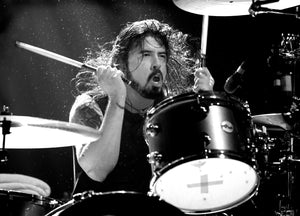 Dave Grohl on stage drumming at Hammersmith Apollo 2009 performing with Them Crooked Vultures photographed in black and white by Tina K