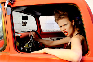 Model Ani Alitalo of Finland’s Next Top Model sitting in orange pick-up truck with punk look and attitude 