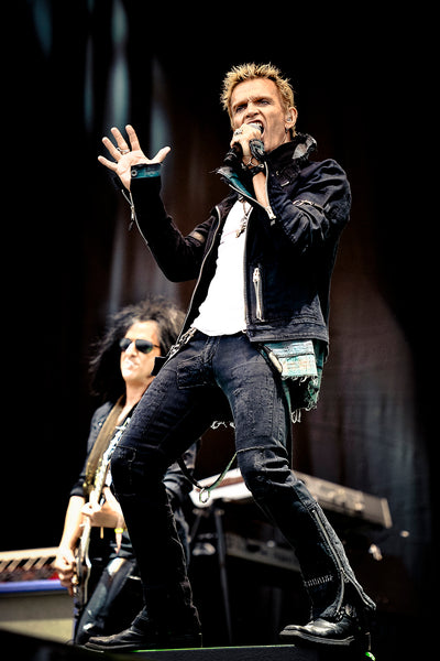 Print of Billy Idol and Steve Stevens on stage at Download 2010 in rain