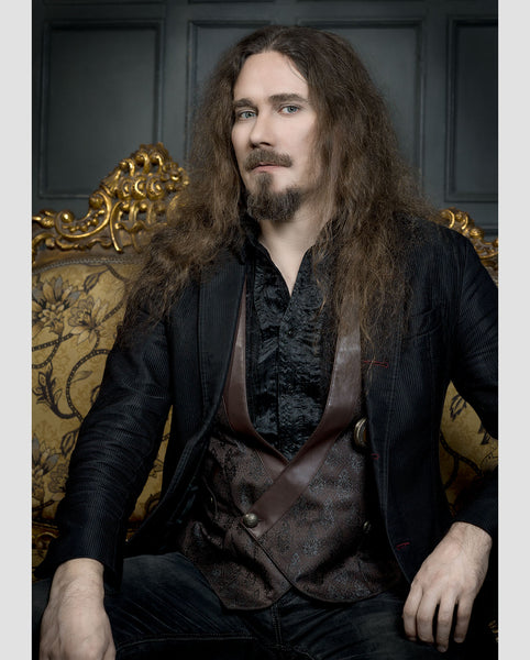Tuomas Holopainen of Finnish symphonic metal band Nightwish, sitting on elaborate gold sofa. Photo by Tina K Photography.