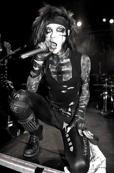 Andy Biersack of Black Veil Brides kneeling on stage with black makeup at the Forum in London 2011. Black and white print signed by Tina K Photography.