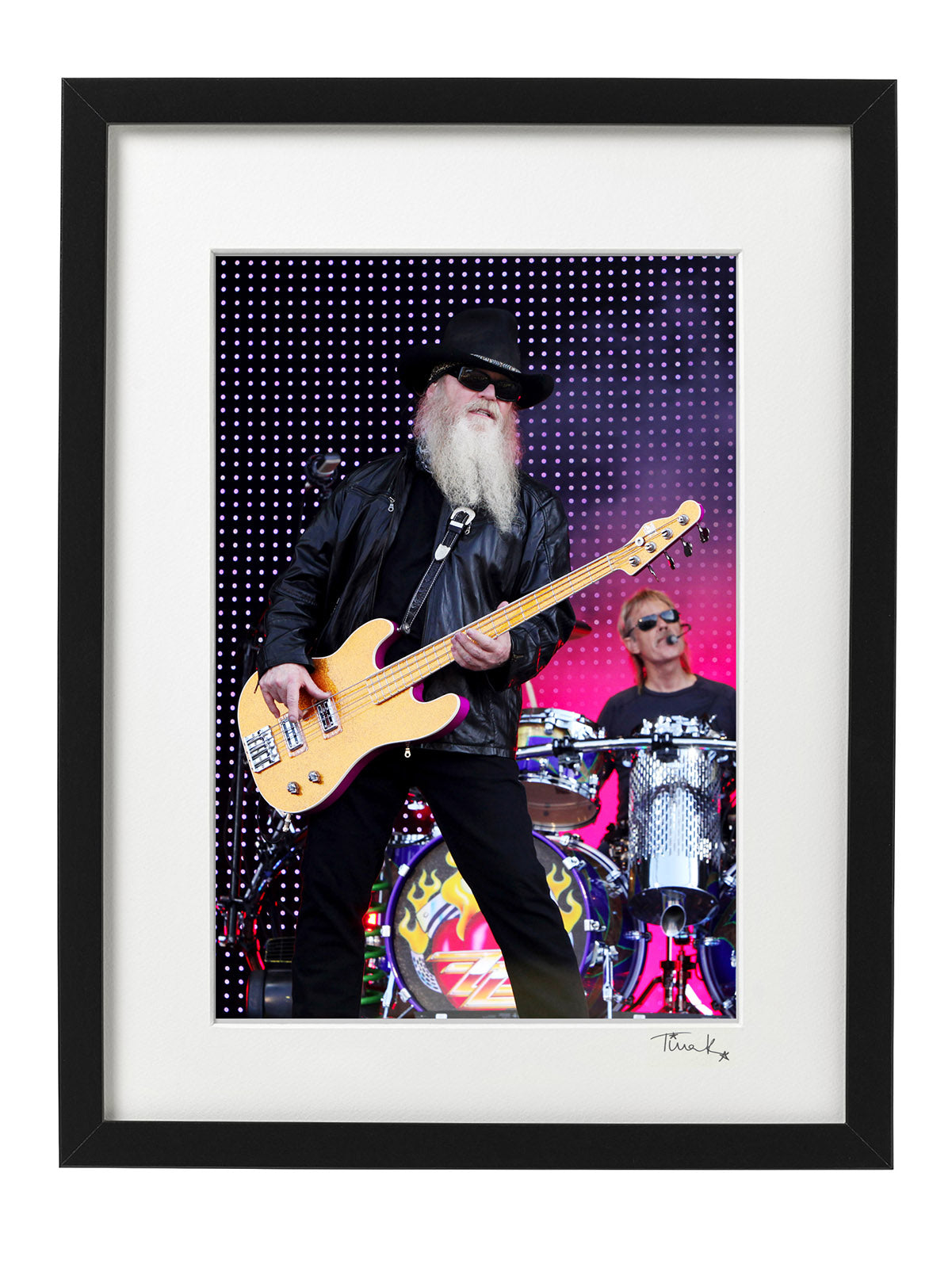 Dusty Hill of ZZ Top with bass guitar and black hat on stage at Download Festival 2009, Frank Beard drumming in background. Original framed print, signed by Tina K Photography.